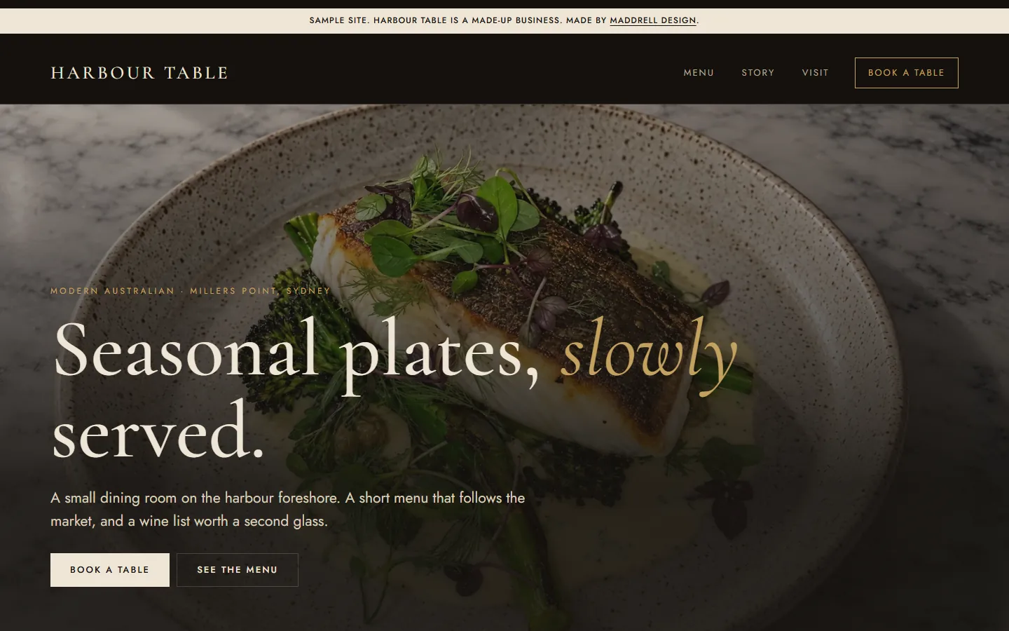 Harbour Table sample restaurant site: a dark page with a plated fish dish behind the headline, Seasonal plates, slowly served