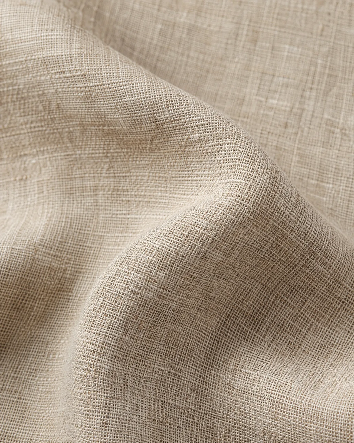 Close view of natural linen weave in soft folds